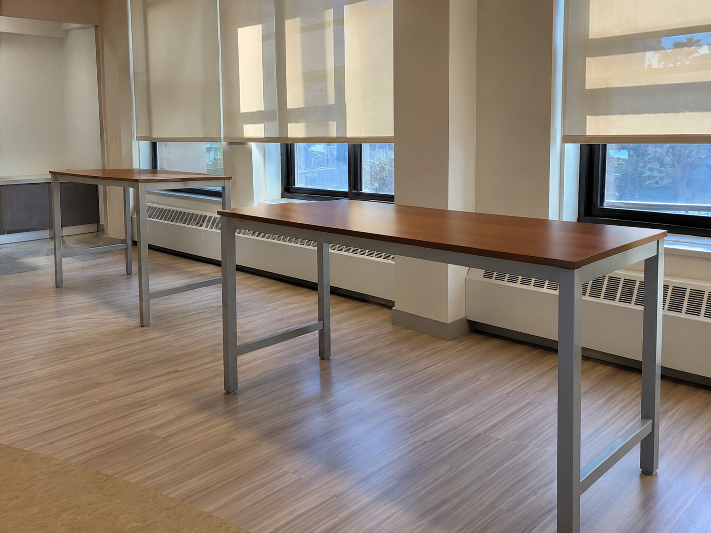Two wood worksurfaces prepared for custom electrical-module cutouts