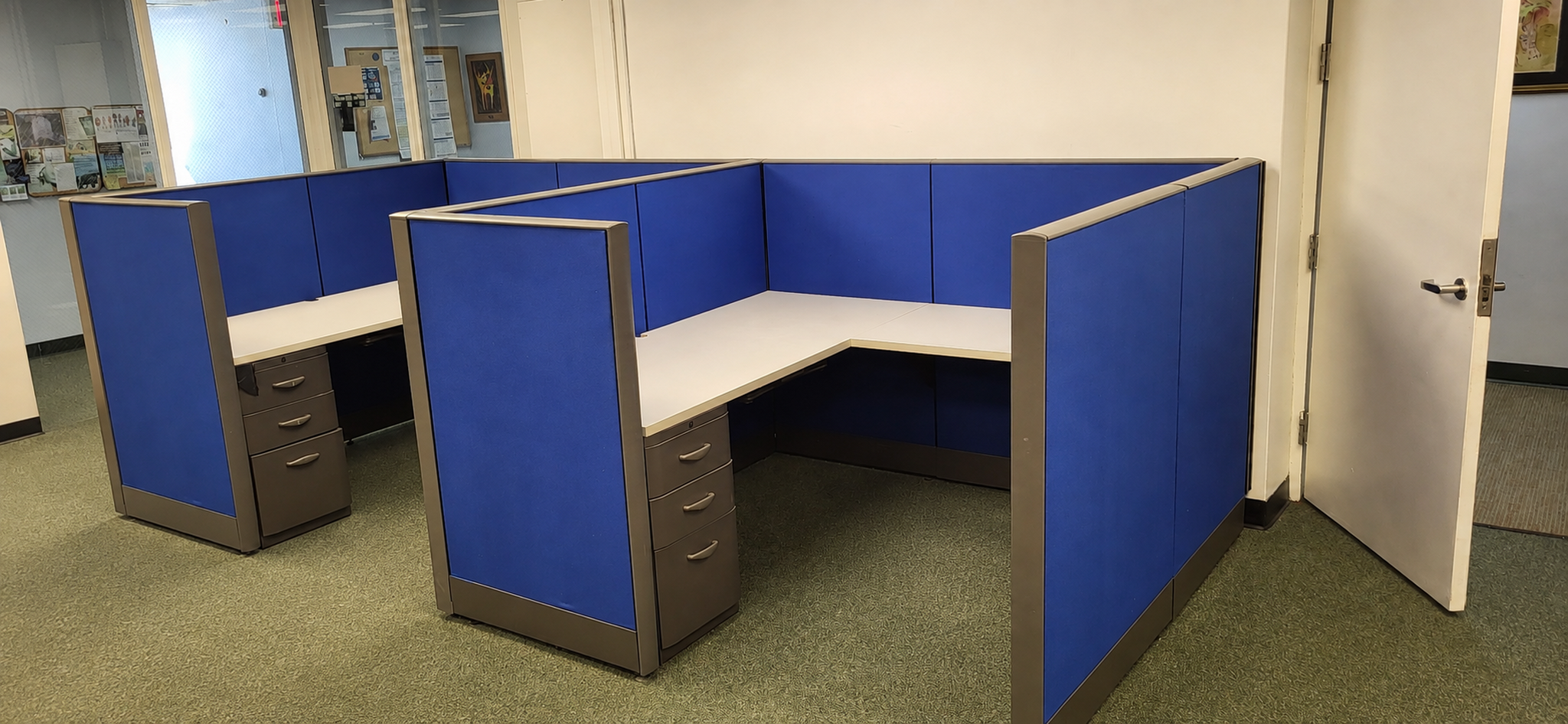 Detailed view of completed blue workstations with storage