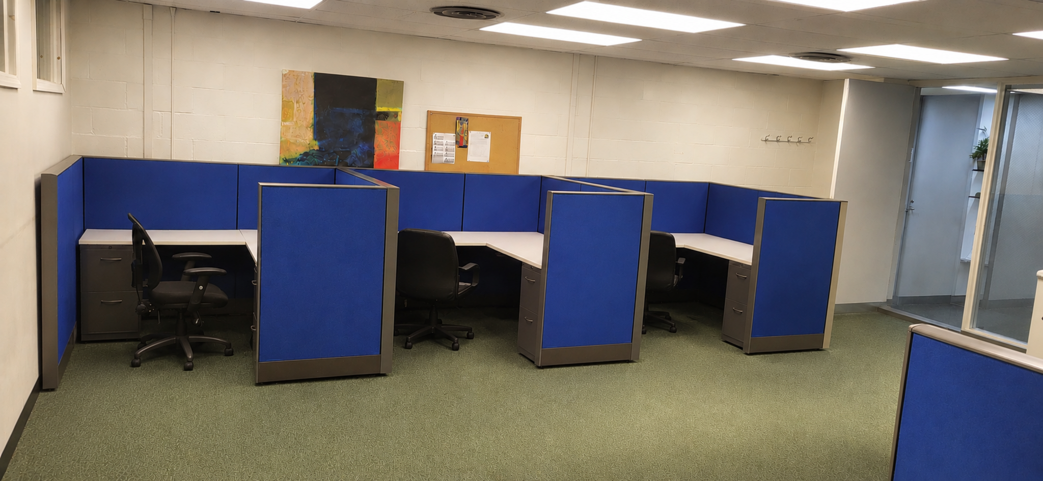 Completed blue cubicle installation in the reconfigured office